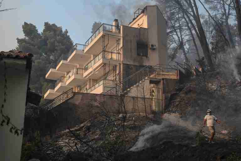 Tourists flee as Greek wildfire descends on resort village